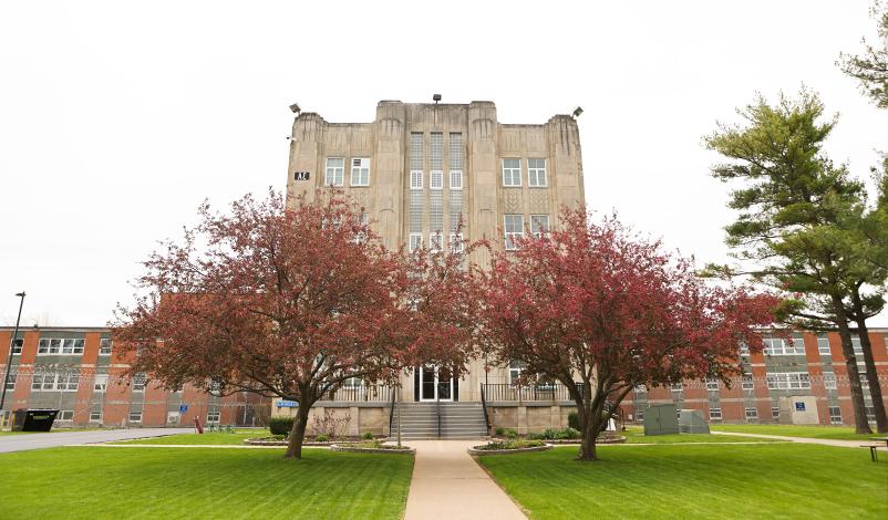 The Mount Pleasant Correctional Facility building, framed by blooming trees in the spring