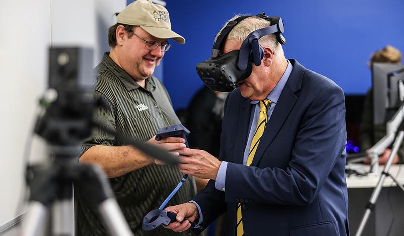 Mount Mercy President, Dr. Todd A. Olson, demonstrates virtual reality equipment